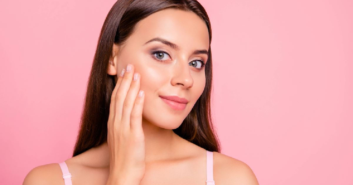 Woman touching her smooth, glowing cheek after receiving Dermaplaning Treatment in Chesapeake, VA